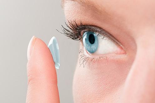 A woman applying contact lenses.